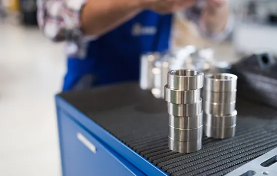 Engineer inspecting a precision industrial casting before dispatch